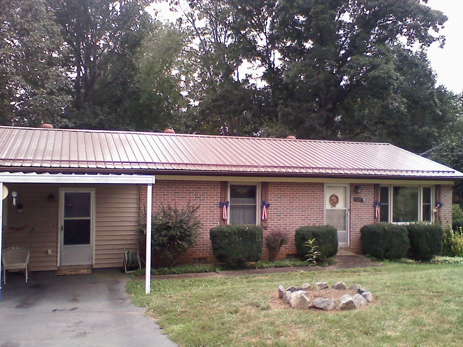 Bronze metal roof and carport on a brick ranch home — Roof Repair work by our crew in Pocono Summit